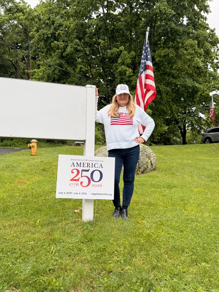 hat Woman wearing RCA250 Hat near an RCA250 sign
